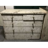 An antique painted pitch pine five drawer chest