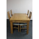 A contemporary oak extending dining table and four high back chairs