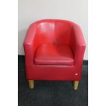 A tub chair in red vinyl
