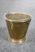 An antique brass swing handled fire bucket