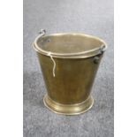 An antique brass swing handled fire bucket