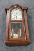 A Tempus Fugit wall clock with pendulum key and weights