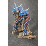 Two contemporary wooden figures of blue dragons