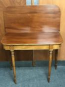 A Victorian mahogany foldover tea table on reeded legs