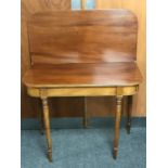 A Victorian mahogany foldover tea table on reeded legs