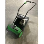 A GTech CMO1 cordless cylinder mower with battery and charger