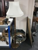 A standard lamp with shade and four assorted mirrors