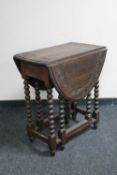 An antique carved oak table on bobbin legs