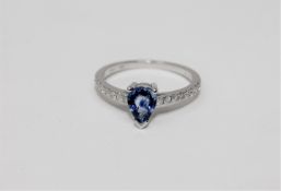 A 14ct white gold sapphire and diamond ring featuring one pear cut natural sapphire 0.