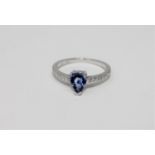 A 14ct white gold sapphire and diamond ring featuring one pear cut natural sapphire 0.