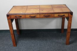 A leather covered writing table fitted four drawers
