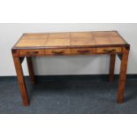 A leather covered writing table fitted four drawers