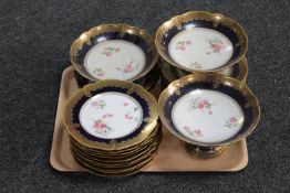 A tray of twenty-one piece Limoges gilded serving set comprising of plates and comports