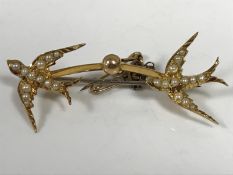 A 15ct gold swallow brooch set with seed pearls