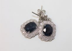 A pair of 18ct white gold sapphire and diamond earrings,