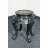 An oriental style ebonised plant stand