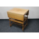 An oak two tier flap sided trolley