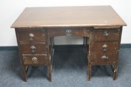 An early 20th century oak twin pedestal desk