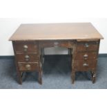 An early 20th century oak twin pedestal desk