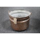 An antique copper swing handled cooking pot