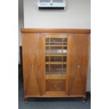 A continental oak triple door cabinet with mother of pearl inlay