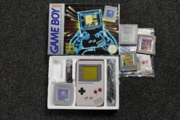 A boxed Nintendo Game Boy with Tetris game and accessories and three further Game Boy games