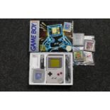 A boxed Nintendo Game Boy with Tetris game and accessories and three further Game Boy games