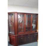 A contemporary inlaid mahogany triple door display cabinet fitted with cupboards and doors beneath