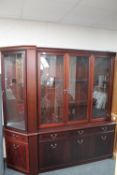 A contemporary inlaid mahogany triple door display cabinet fitted with cupboards and doors beneath