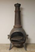 A cast metal outdoor chimenea