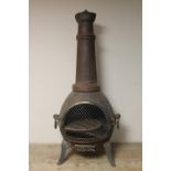 A cast metal outdoor chimenea