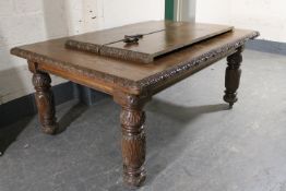 A heavily carved Victorian oak wind out dining table with two leaves CONDITION REPORT:
