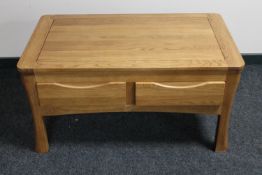A contemporary oak coffee table fitted four drawers