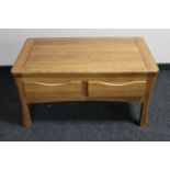 A contemporary oak coffee table fitted four drawers