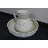 A cream pottery wash jug and basin