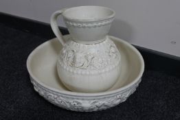 A cream pottery wash jug and basin