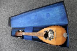 An eight string bowl back mandolin with mother of pearl inlay in case