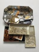 A tin of costume jewellery, 9ct gold earrings, cameo brooch,