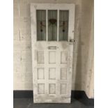 An early 20th century exterior door with stained leaded glass panels