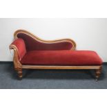 A Victorian mahogany chaise longue in red fabric