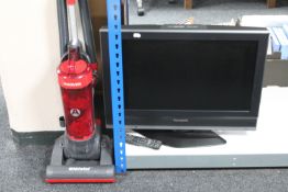 A Panasonic Viera 26" LCD TV together with a Hoover Whirlwind upright vacuum