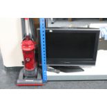 A Panasonic Viera 26" LCD TV together with a Hoover Whirlwind upright vacuum
