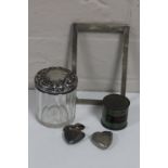 A tin of silver picture frame, silver lidded jar, heart shaped vesta box and one other,