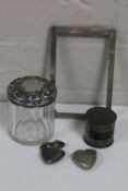 A tin of silver picture frame, silver lidded jar, heart shaped vesta box and one other,