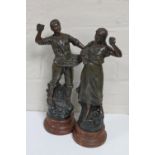 A pair of early 20th century spelter figures of harvesters on wooden bases