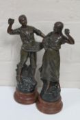 A pair of early 20th century spelter figures of harvesters on wooden bases