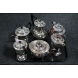 A tray of six silver plated tea and coffee pots