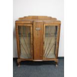 A 1930's walnut double door display cabinet