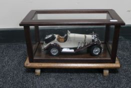 A die cast vintage Mercedes Benz in a wooden display case