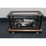 A die cast vintage Mercedes Benz in a wooden display case